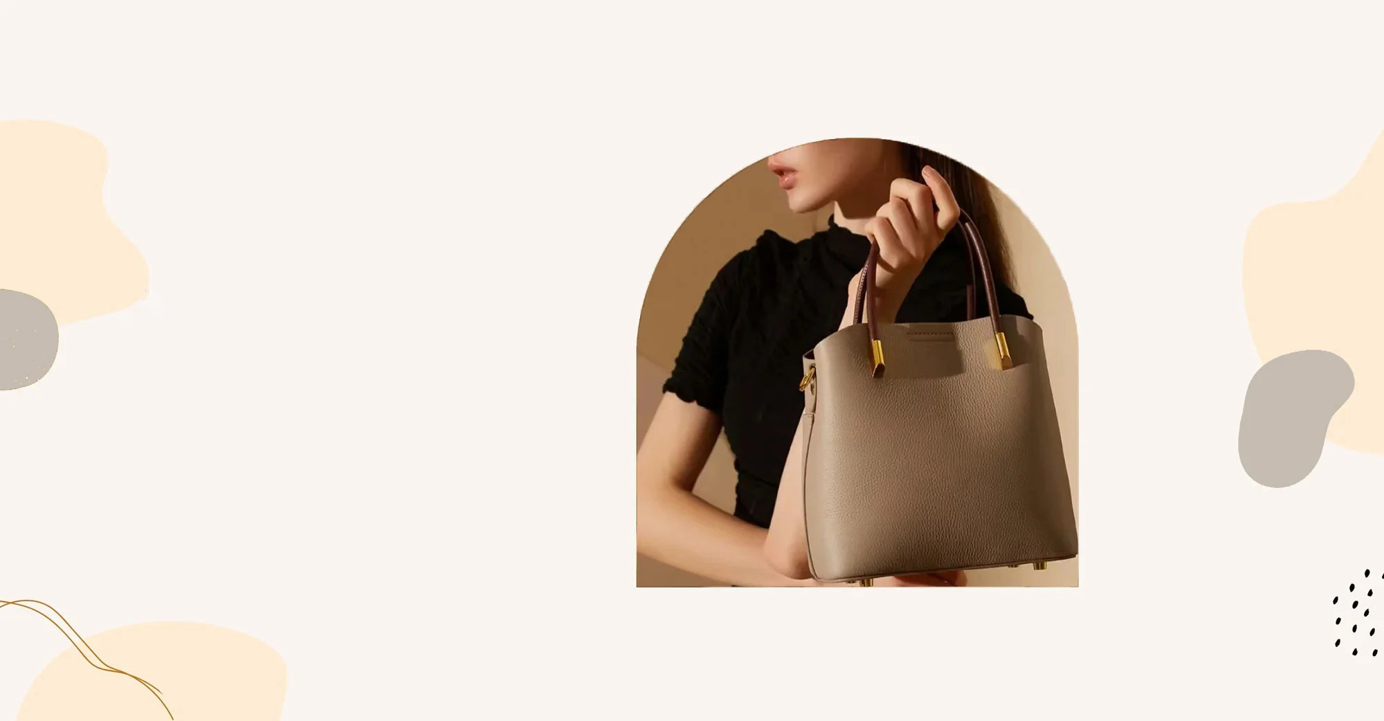 Homepage Luxe Bucket Carry beige luxury leather handbag with upscale gold hardware held by model in black top showcasing elegant handheld carry styleslider_item_J33Ed7