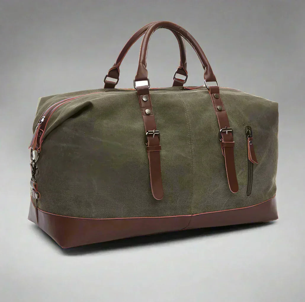 Timeless Travel Carry bag in green durable canvas with genuine brown leather accents structured silhouette dual top handles adjustable detachable shoulder strap and reinforced leather base showcasing luxury travel styling upscale craftsmanship premium finish and spacious carry on friendly design