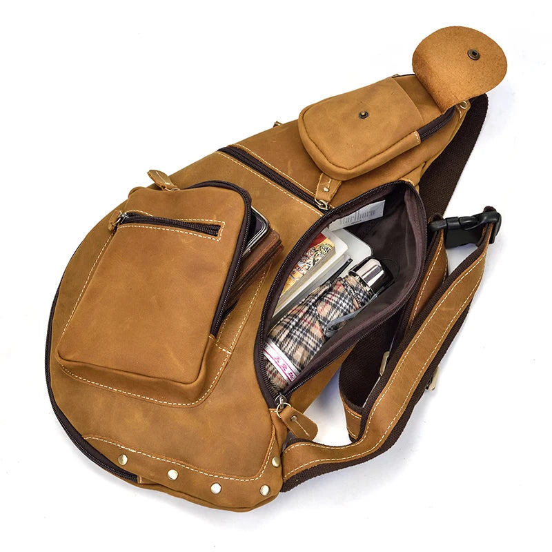 Heritage Nomad Sling men's brown leather crossbody sling bag with multiple pockets, open to show items inside