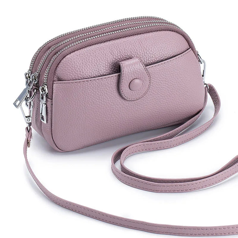 Signature Convertible Carry women’s crossbody bag in lilac genuine leather with zip closures, front snap pocket, adjustable strap with silver hardware