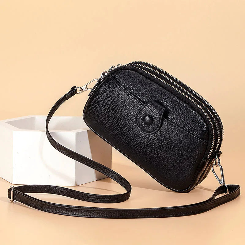 Signature Convertible Carry women’s black pebbled leather crossbody bag with detachable adjustable strap and 3 pocket zip closure with silver hardware