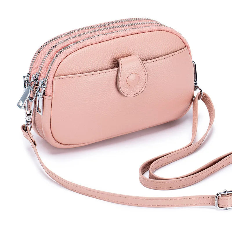 Signature Convertible Carry women’s genuine leather crossbody bag in blush pink with adjustable strap and 3 zip pockets, front snap pocket with silver hardware