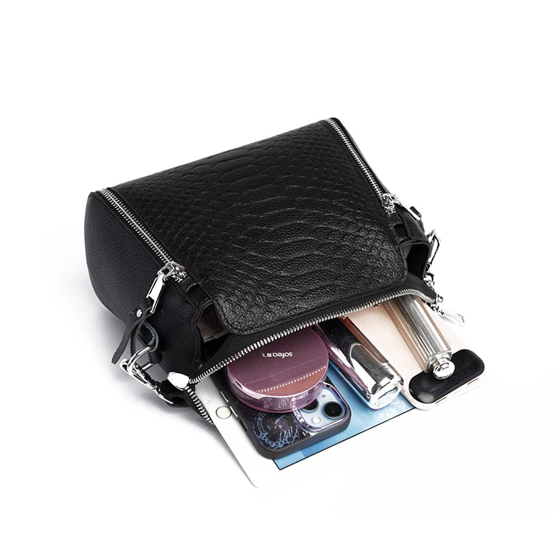 Timeless Zip Carry women’s black textured leather crossbody bag with zipper, open to show contents