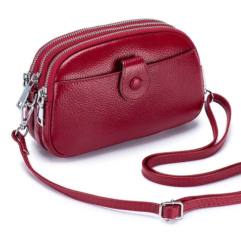 Signature Convertible Carry women’s crossbody bag, red pebbled leather, adjustable strap, zip closures and front snap pocket and silver hardware
