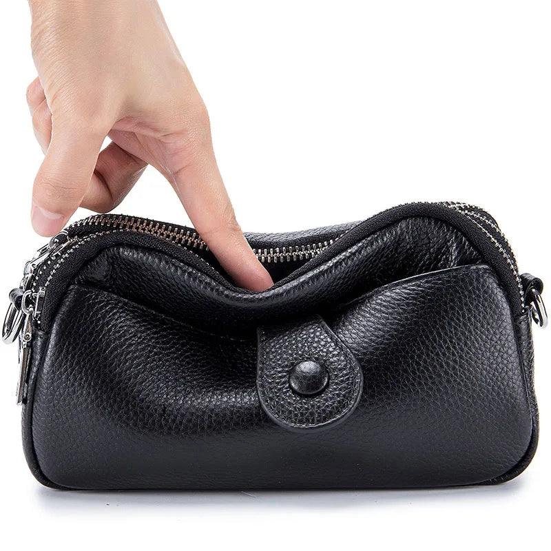 Signature Convertible Carry black leather women's clutch bag with zip closure and front snap pocket with silver hardware