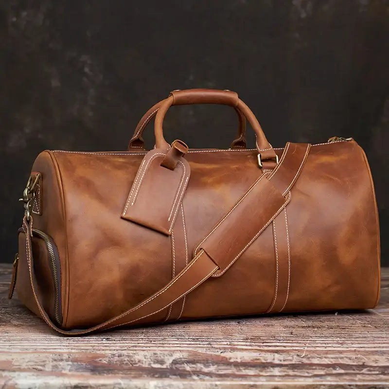 Heritage Leather Weekender in brown thick vintage luxury genuine leather with structured duffel silhouette dual top handles detachable shoulder strap and copper hardware showcasing classic craftsmanship rich patina premium organization and timeless travel ready design