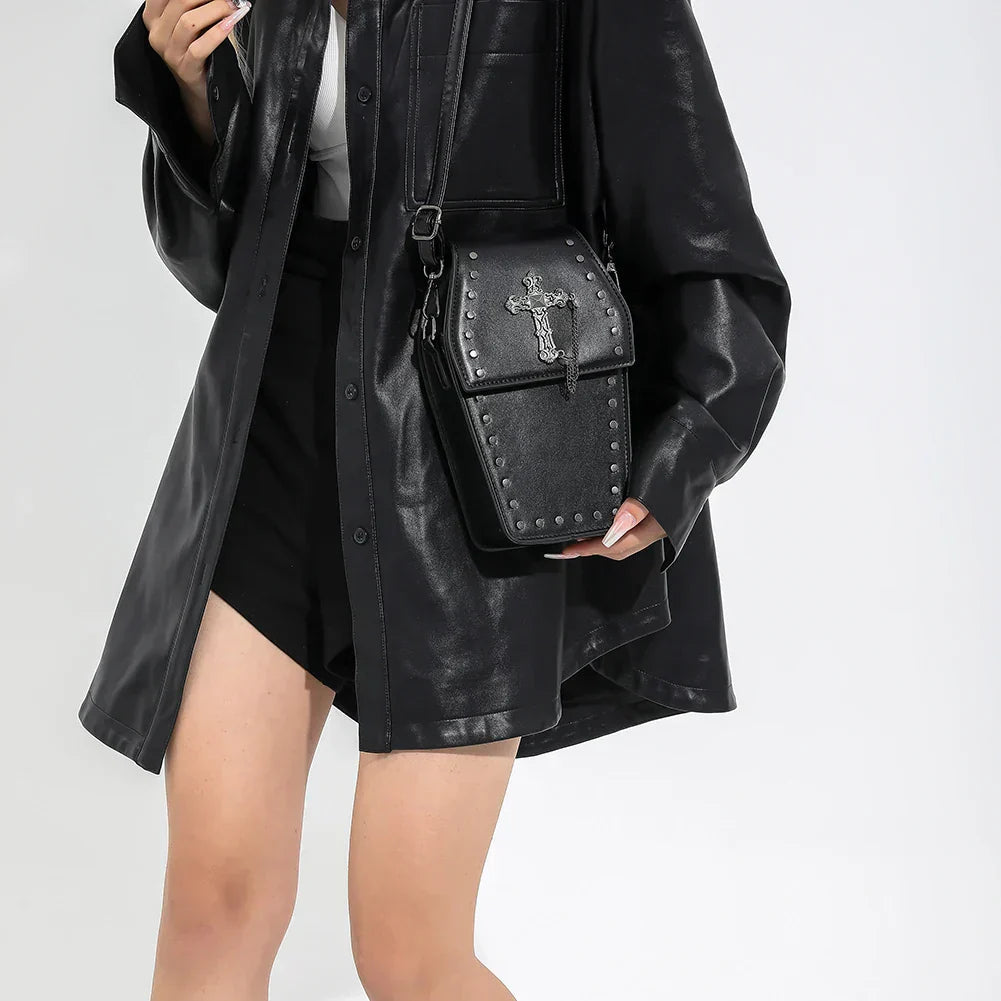 Midnight Edge Crossbody bag in luxury black vegan leather shown worn by model featuring structured silhouette flap closure and adjustable strap showcasing bold unconventional design and durable premium construction for edgy upscale everyday styling