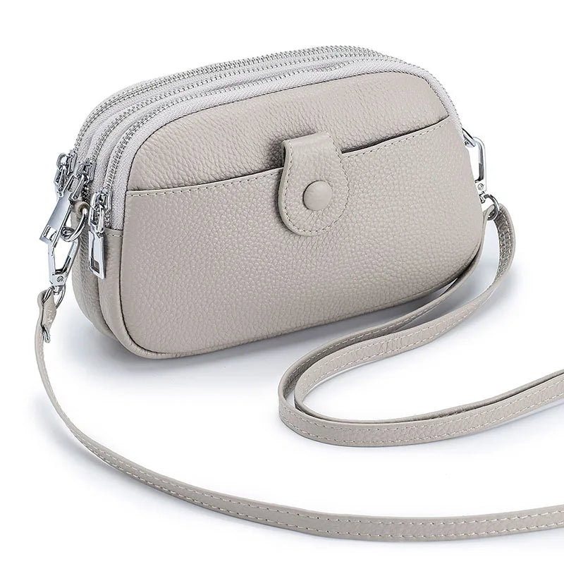 Signature Convertible Carry women's genuine leather crossbody bag in light grey with pebbled texture with silver hardware 3 zip pockets and a front snap pocket