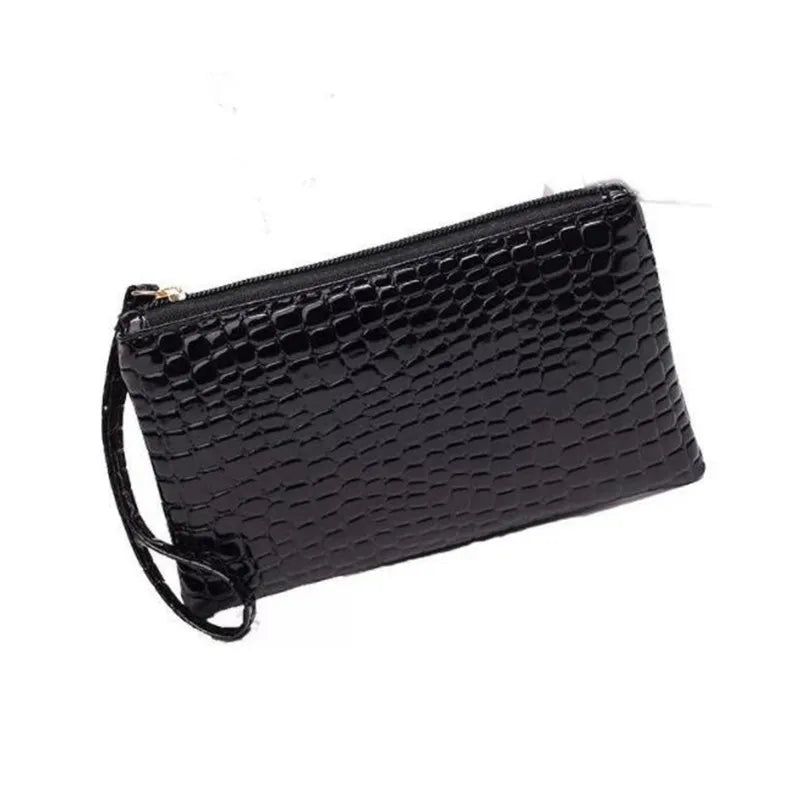 black timeless croc wristlet vegan leather clutch bag pairs with a leather tote bag