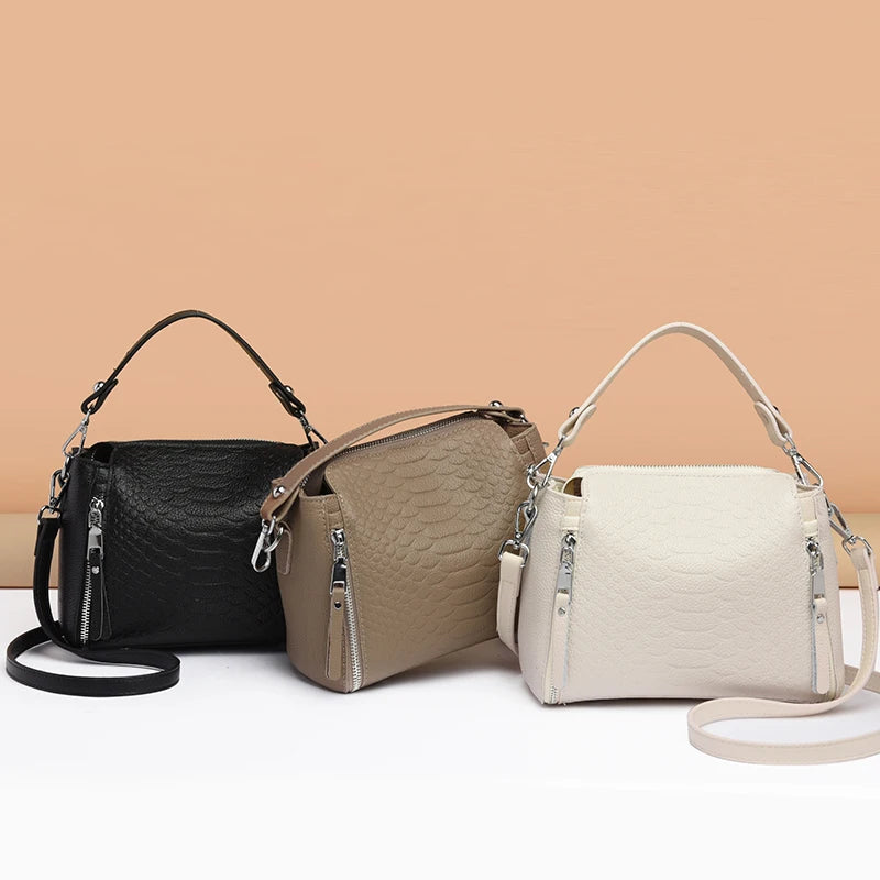 Timeless Zip Carry women’s crossbody bags in black, taupe, and cream genuine leather with textured finish and top handles