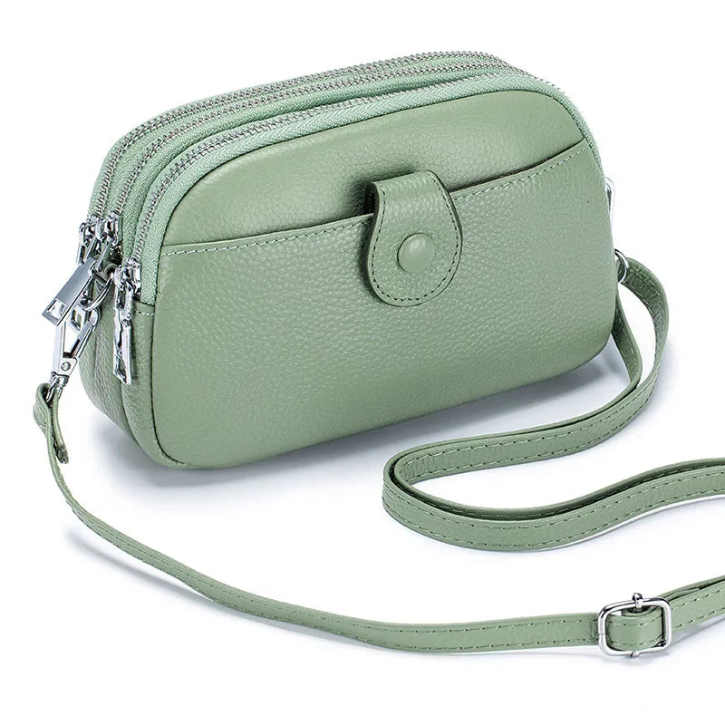 Signature Convertible Carry women's genuine leather sage green crossbody bag with adjustable strap, front snap pocket, 3 zip pockets with silver hardware