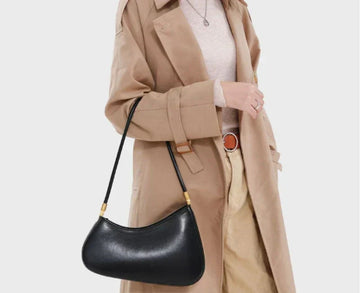 Timeless Arc Carry shoulder bag, women’s, black leather with gold-tone hardware, worn over the arm