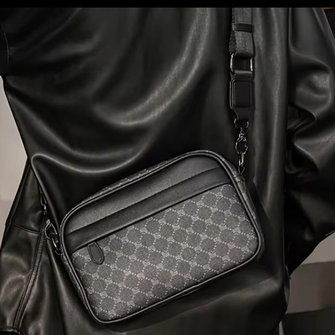 Urban Axis Crossbody crossbody bag in black patterned premium vegan leather with zippered main compartment front zip pocket and detachable adjustable black strap worn crossbody showcasing iconic styling and upscale everyday utility