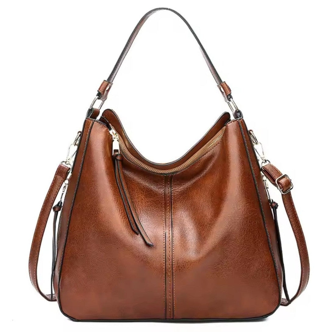 emium vegan leather with relaxed crescent silhouette single top handle adjustable detachable shoulder strap and zippered main compartment showcasing luxury soft texture upscale detailing spacious interior and versatile everyday design