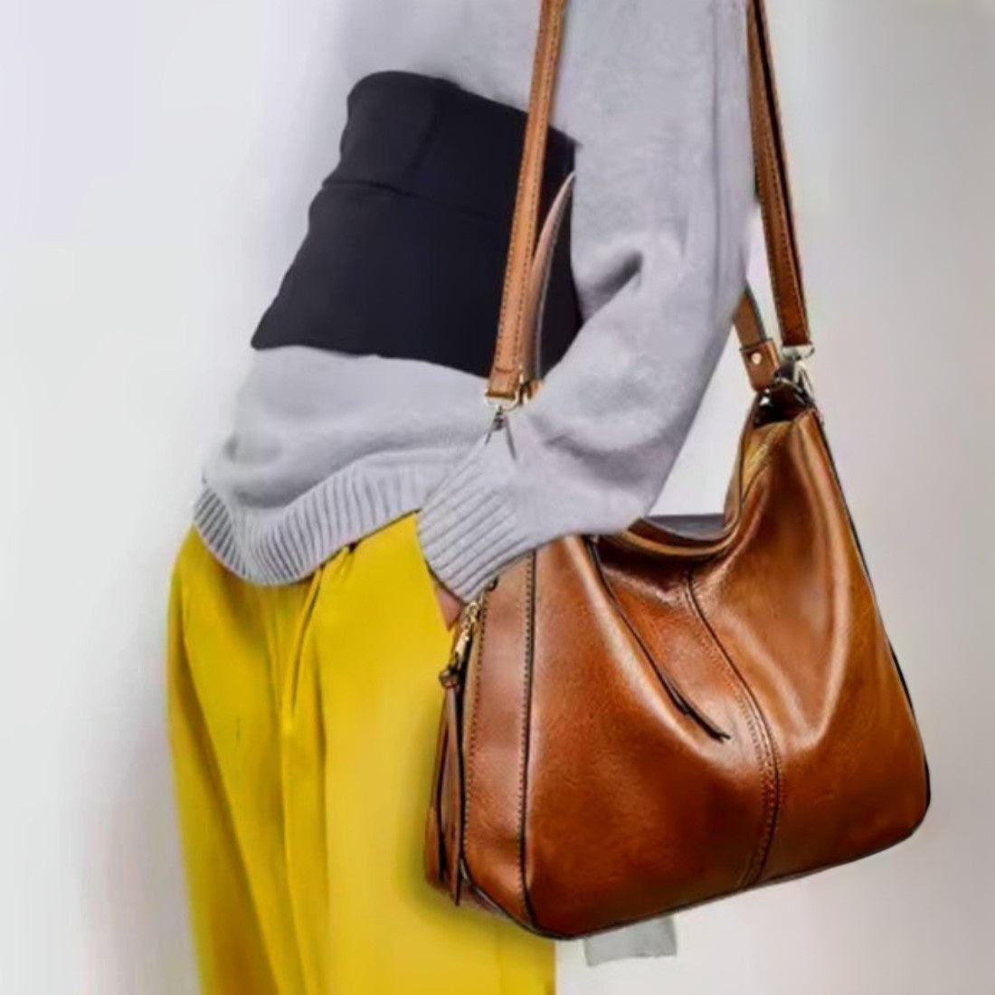 Classic Carry Hobo in brown premium vegan leather with relaxed crescent silhouette and wide shoulder strap worn by model showcasing effortless styling upscale craftsmanship and versatile everyday luxury durable design