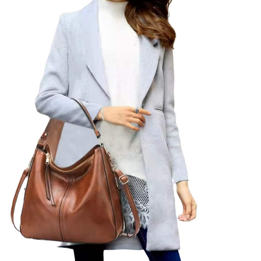 Classic Carry Hobo in brown premium vegan leather with relaxed crescent silhouette wide shoulder strap and slouchy structure held by model showcasing effortless luxury styling upscale craftsmanship and versatile everyday elegant design