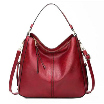Classic Carry Hobo in red premium vegan leather with relaxed crescent silhouette single top handle adjustable detachable shoulder strap and zippered main compartment showcasing soft texture upscale detailing spacious interior and versatile everyday luxury design