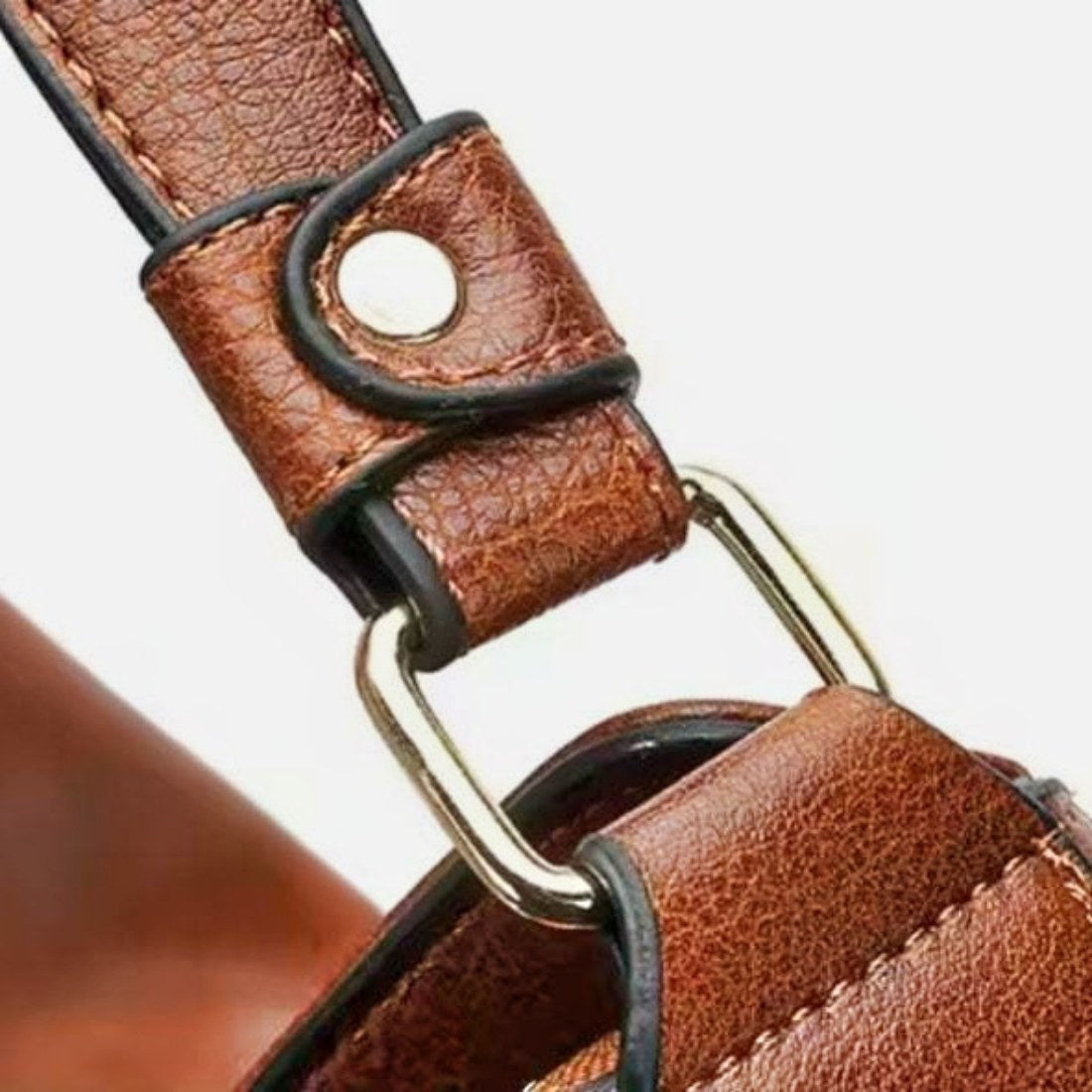 Classic Carry Hobo in brown premium vegan leather showing durable textured strap with upscale stitched edges riveted loop and rectangular metal ring attachment showcasing refined craftsmanship secure hardware and durable everyday elegant design