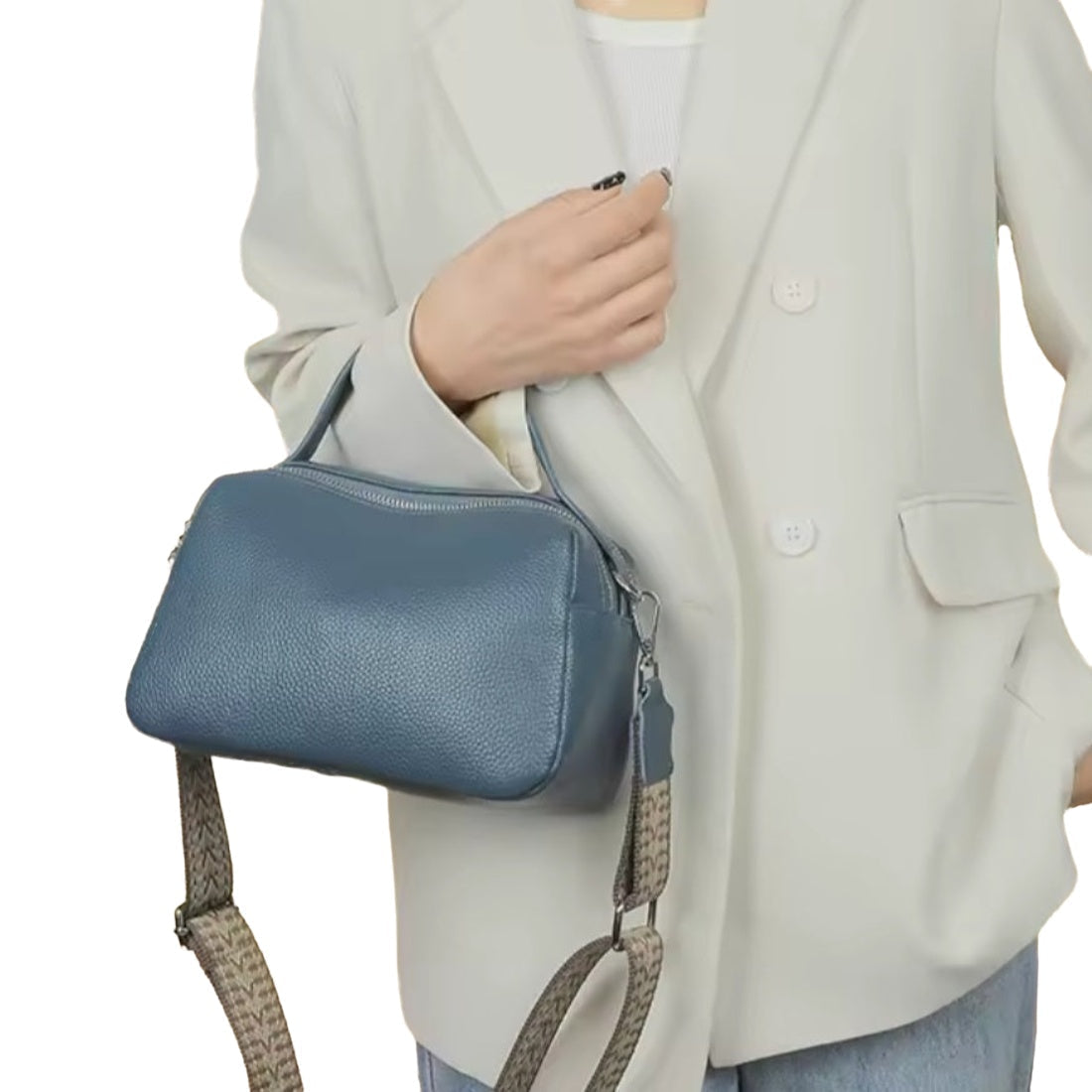 Timeless City Compact crossbody bag in luxury blue pebbled genuine leather with short top leather handle and premium upscale detachable strap with beige and brown woven pattern person wearing in lifestyle setting