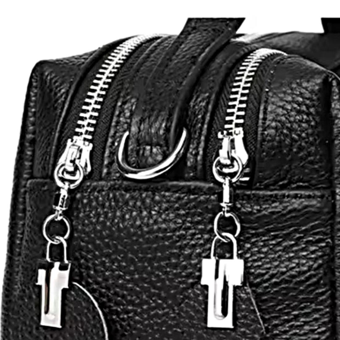 Timeless City Compact crossbody bag in premium black pebbled leather featuring dual silver zippers with oversized rectangular pulls luxurious structured silhouette with elegant stitching and vintage inspired hardware highlighting the bags upscale craftsmanship and dual compartment design