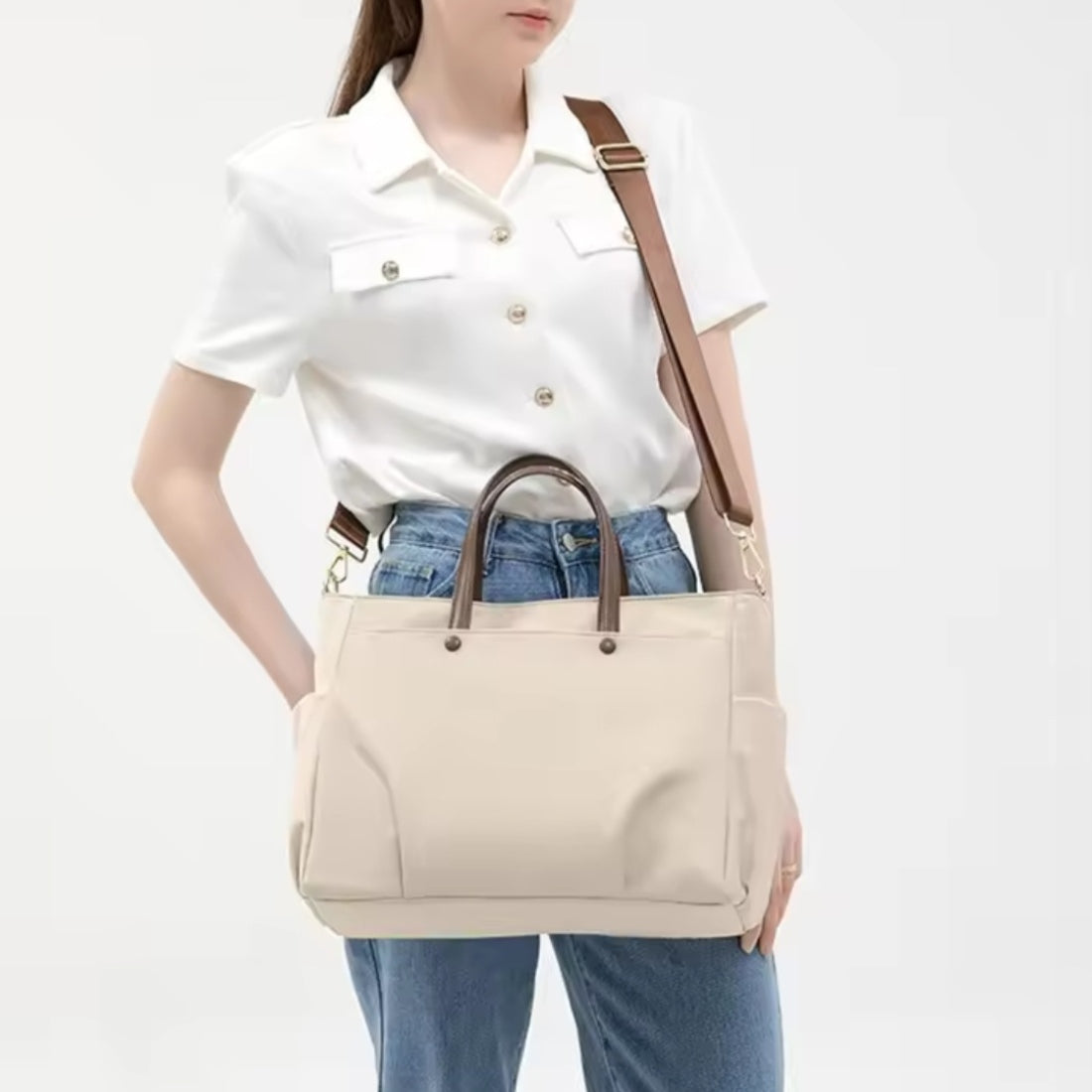 Model wearing upscale premium Timeless Commuter Tote in beige crossbody style with adjustable strap