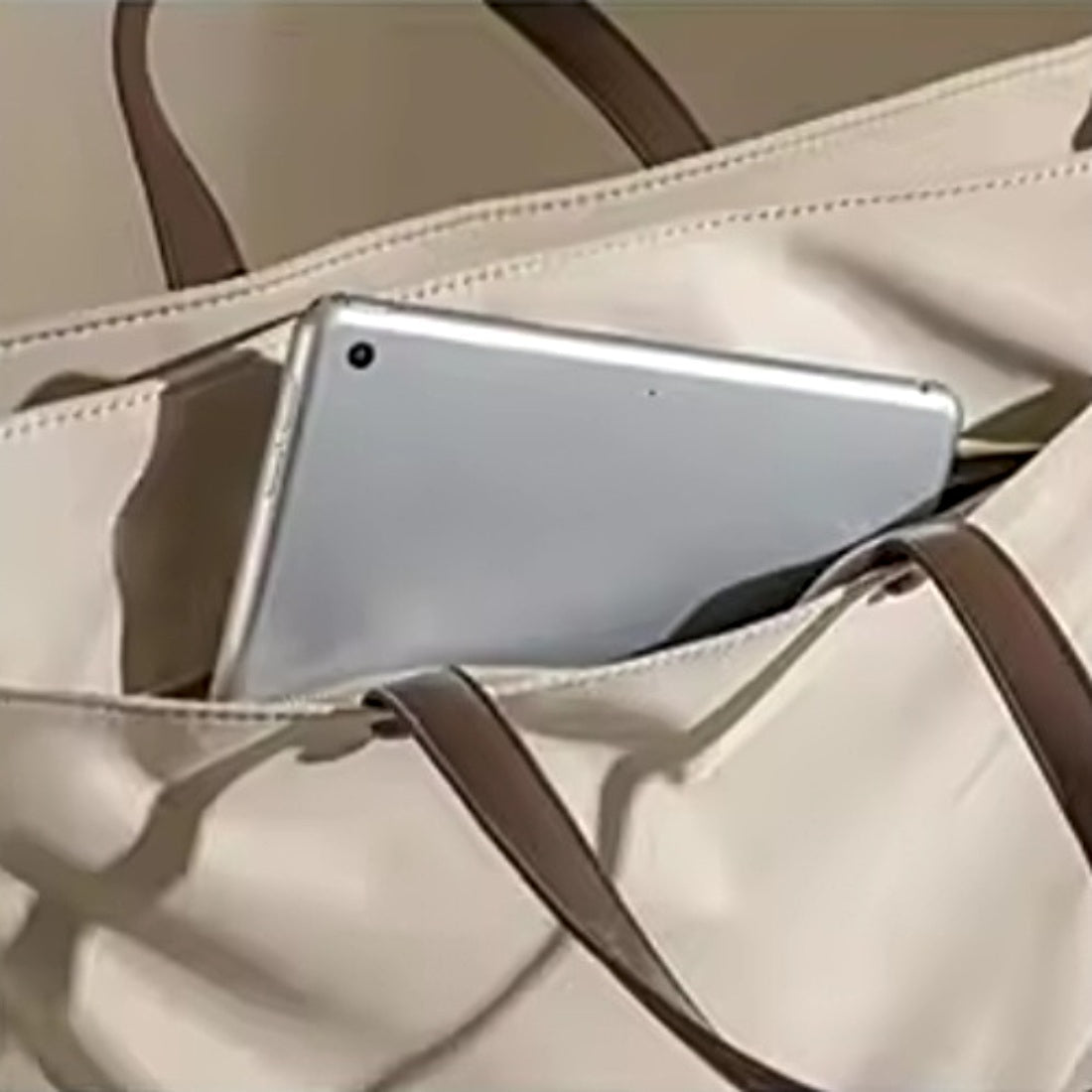 Close up of upscale Timeless Commuter Tote premium front zipper pocket holding a tablet ideal for tech and documents