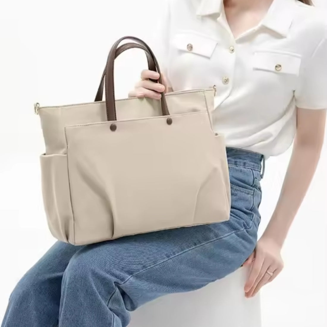 Beige upscale premium Timeless Commuter Tote shown handheld on model lap for size reference
