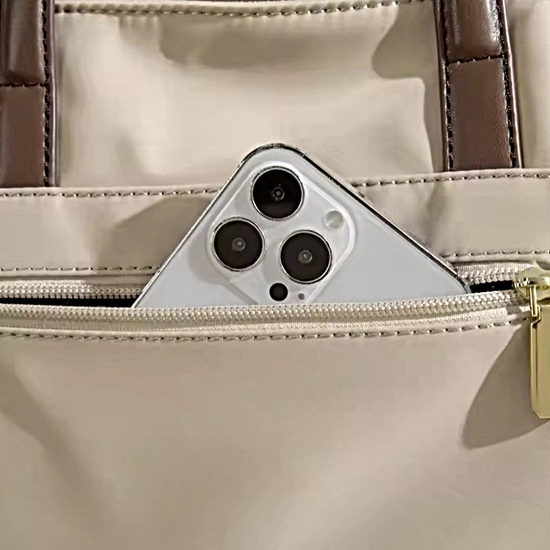 Timeless Commuter Tote in beige showing premium rear anti theft zipper upscale pocket with smartphone inside