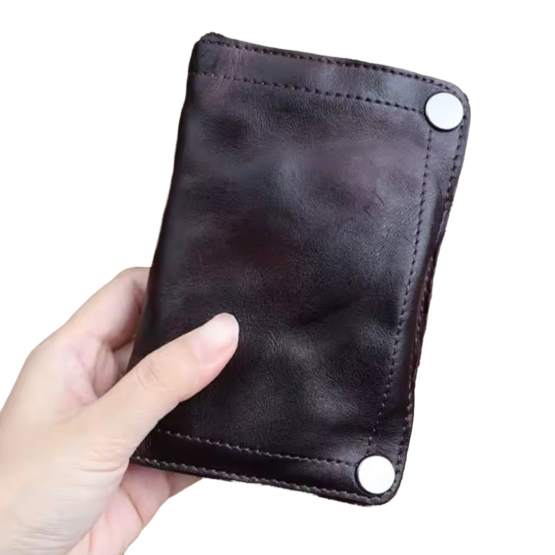 Hand holding Creased Heritage Fold in coffee luxury vintage genuine leather wallet highlighting craftsmanship