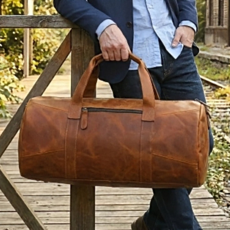 Man holding horizon leather carry mens brown leather travel duffel crossbody bag with an adjustable removable shoulder strap