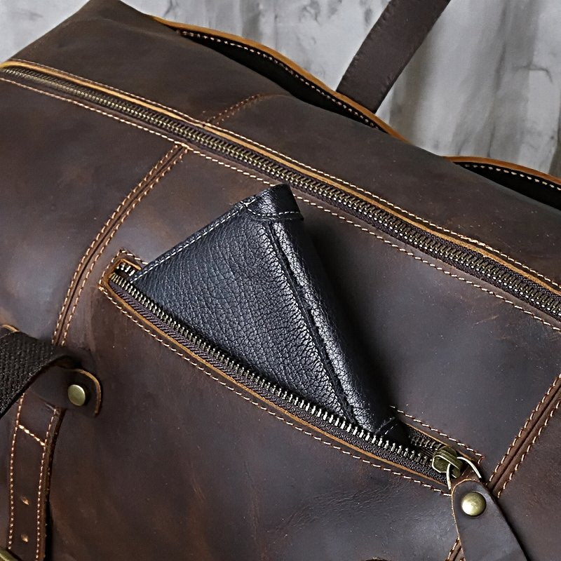 Close-up of a landmark leather weekender brown leather travel duffle bag zip pocket