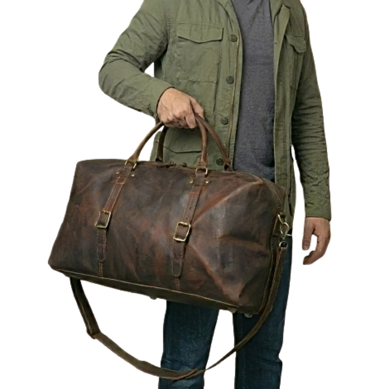 Model holding brown landmark leather weekender travel duffel bag by the handles