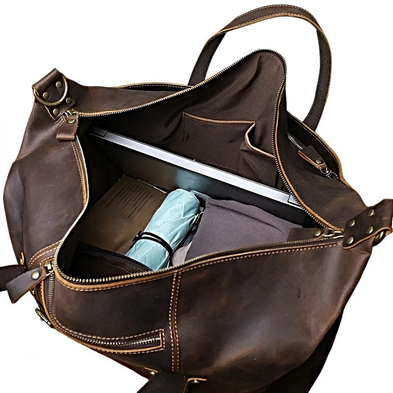landmark leather weekender brown leather travel bag with a laptop and umbrella inside with multiple slip pockets 