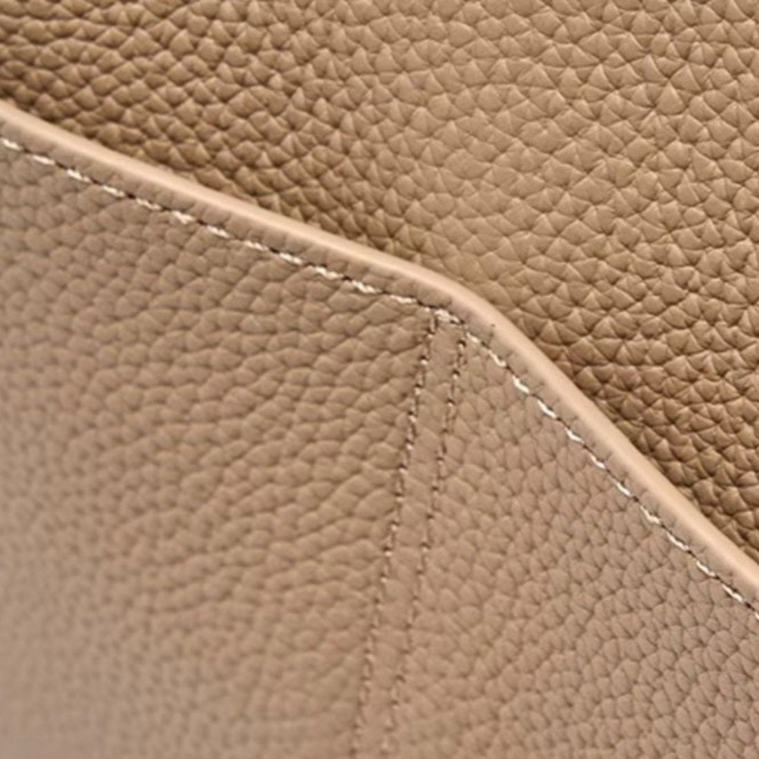 Luxe Bucket Carry upscale elegant handbag close up of premium genuine leather texture with fine stitching detail