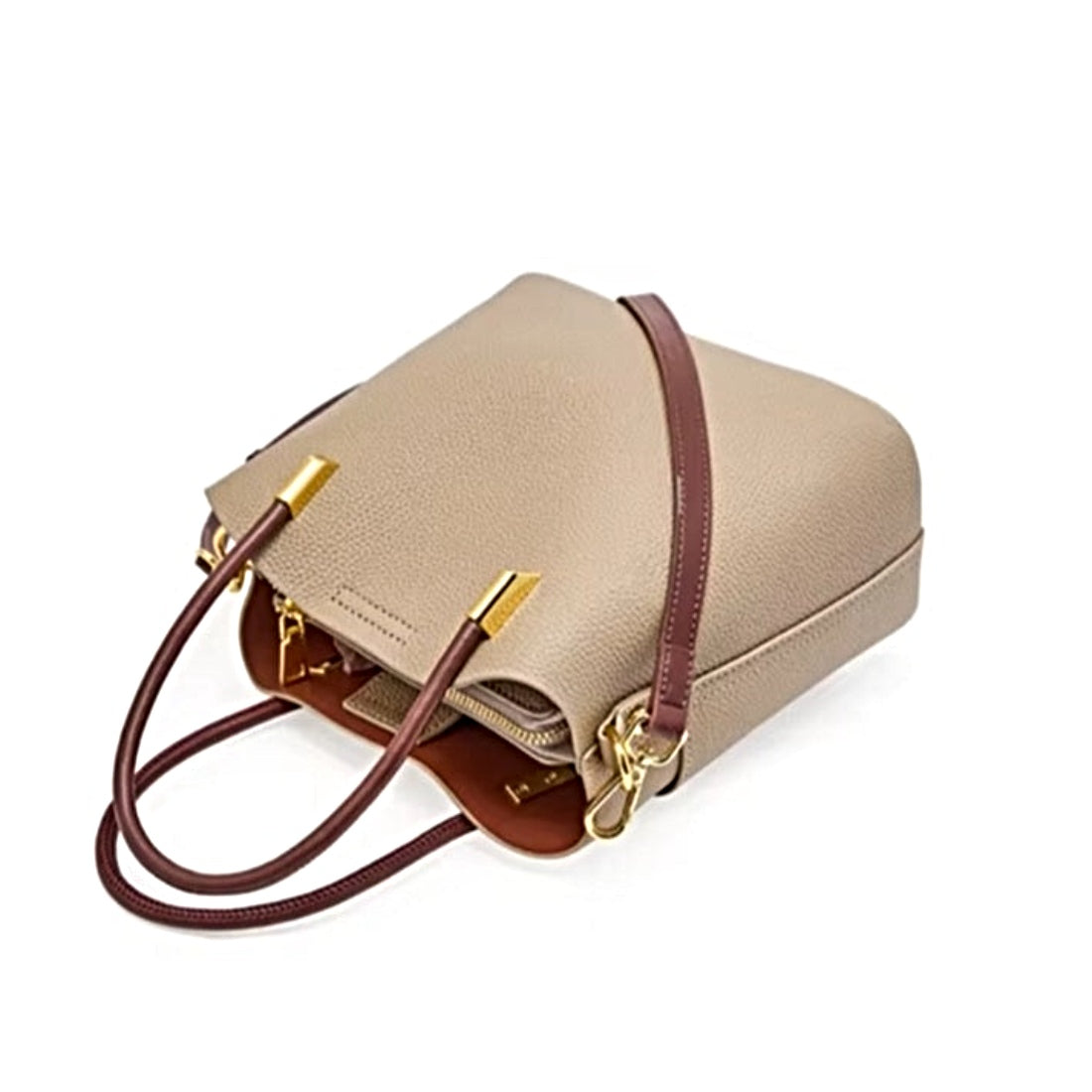Luxe Bucket Carry side profile view in beige premium genuine leather with dual brown handles and upscale elegant  gold  tone hardware on a white background