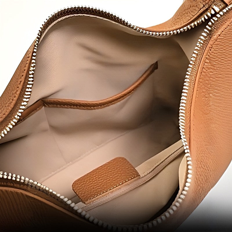 Metro Leather Hobo women's bag interior view showing tan leather, silver zippered opening, and inner pockets