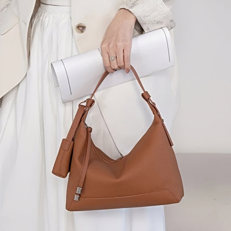 Metro Leather Hobo women's brown leather shoulder bag with textured finish, silver hardware, handheld by model