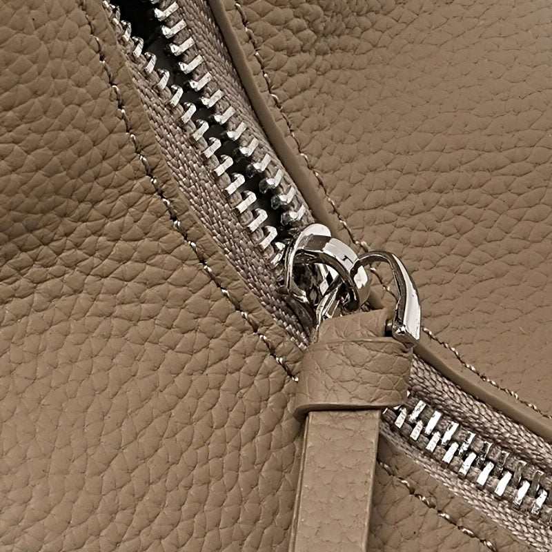 Metro Leather Hobo bag close-up showing taupe pebbled leather texture and silver zipper