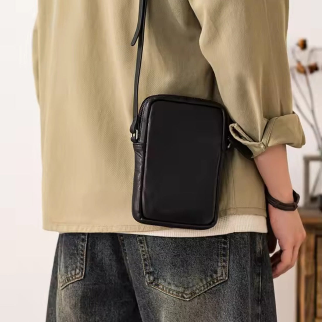 Metroline Carry black compact upscale luxury leather crossbody worn over shoulder
