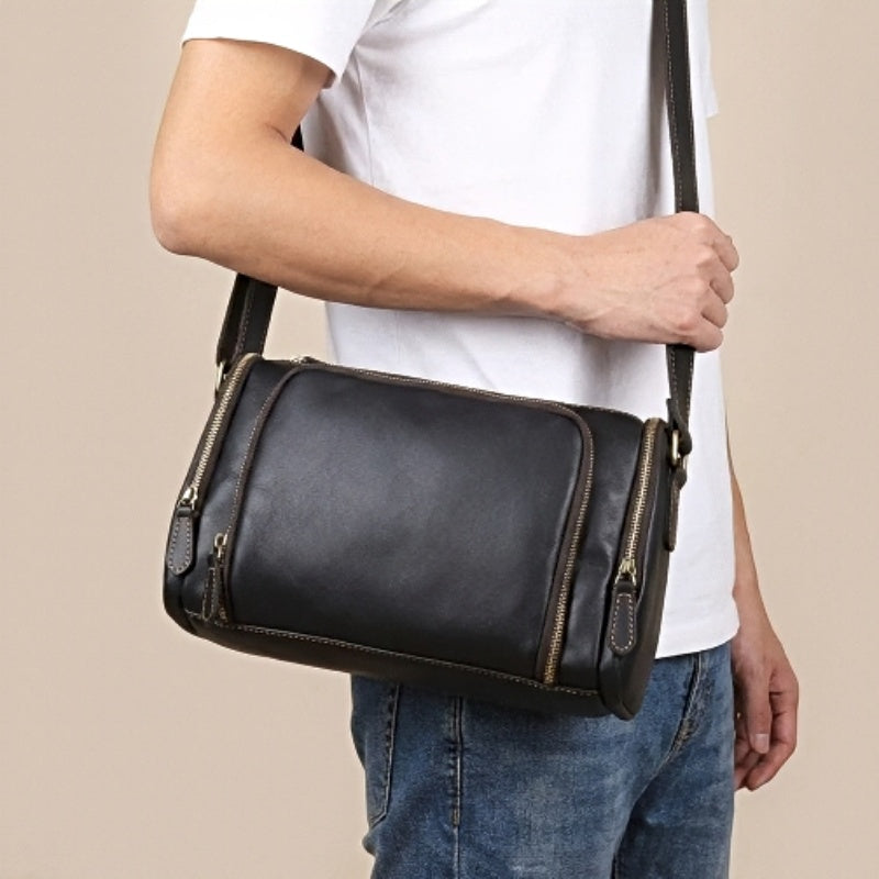 model holding black metroline leather messenger mens leather crossbody bag