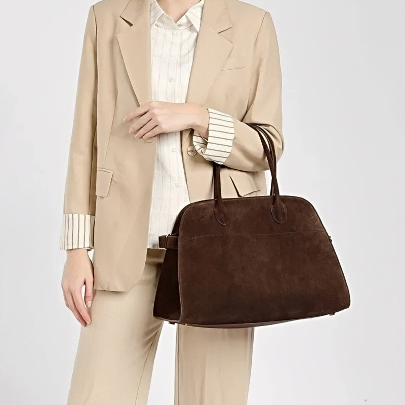 woman holding modern grace tote a large brown leather handbag