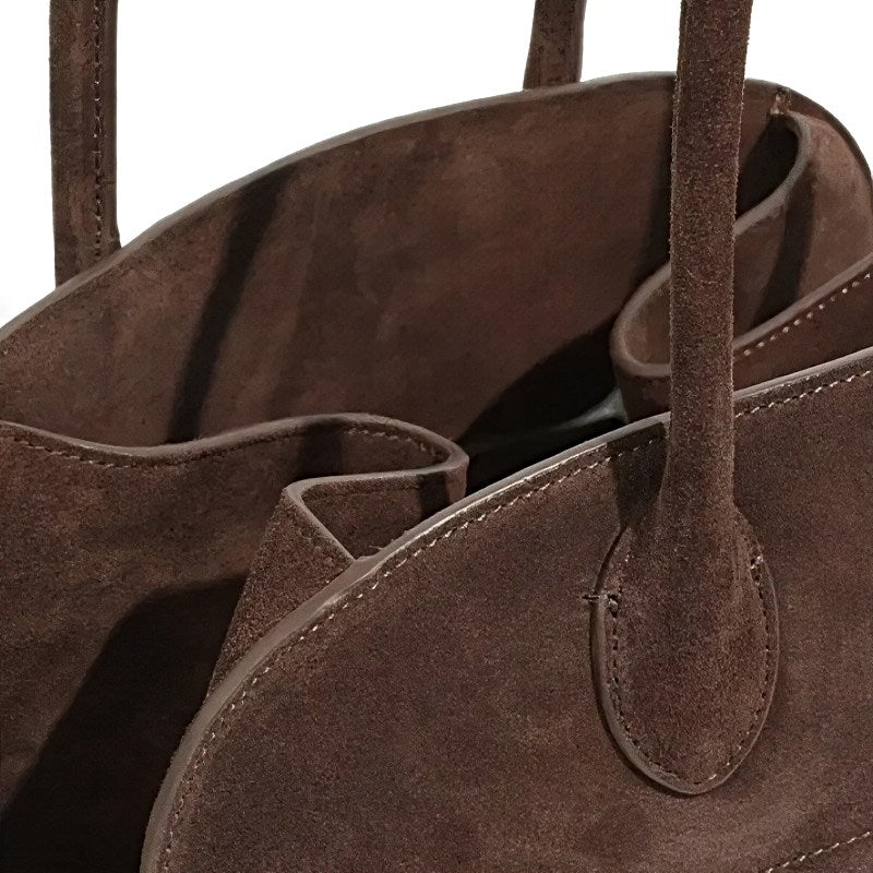 Close-up of modern grace tote a  brown suede womens handbag with visible stitching details
