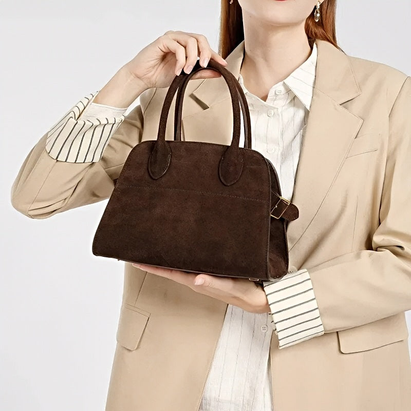 woman holding medium modern grace tote a brown leather handbag 
