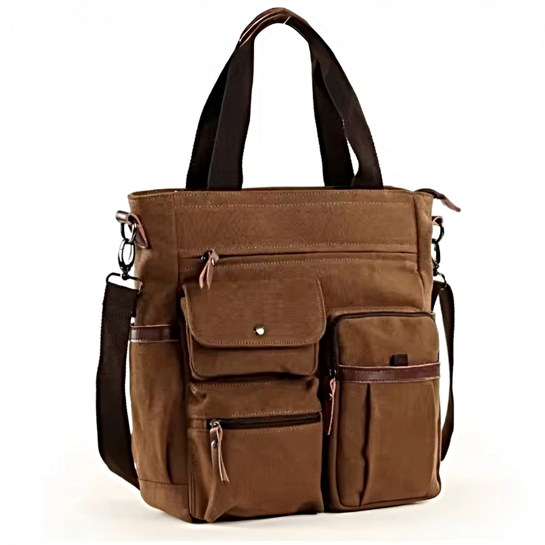 Nomad Utility Carry in black canvas with brown leather accents featuring dual front flap pockets top handles adjustable shoulder strap and zippered compartments showcasing durable premium construction and rugged upscale versatility for everyday carry