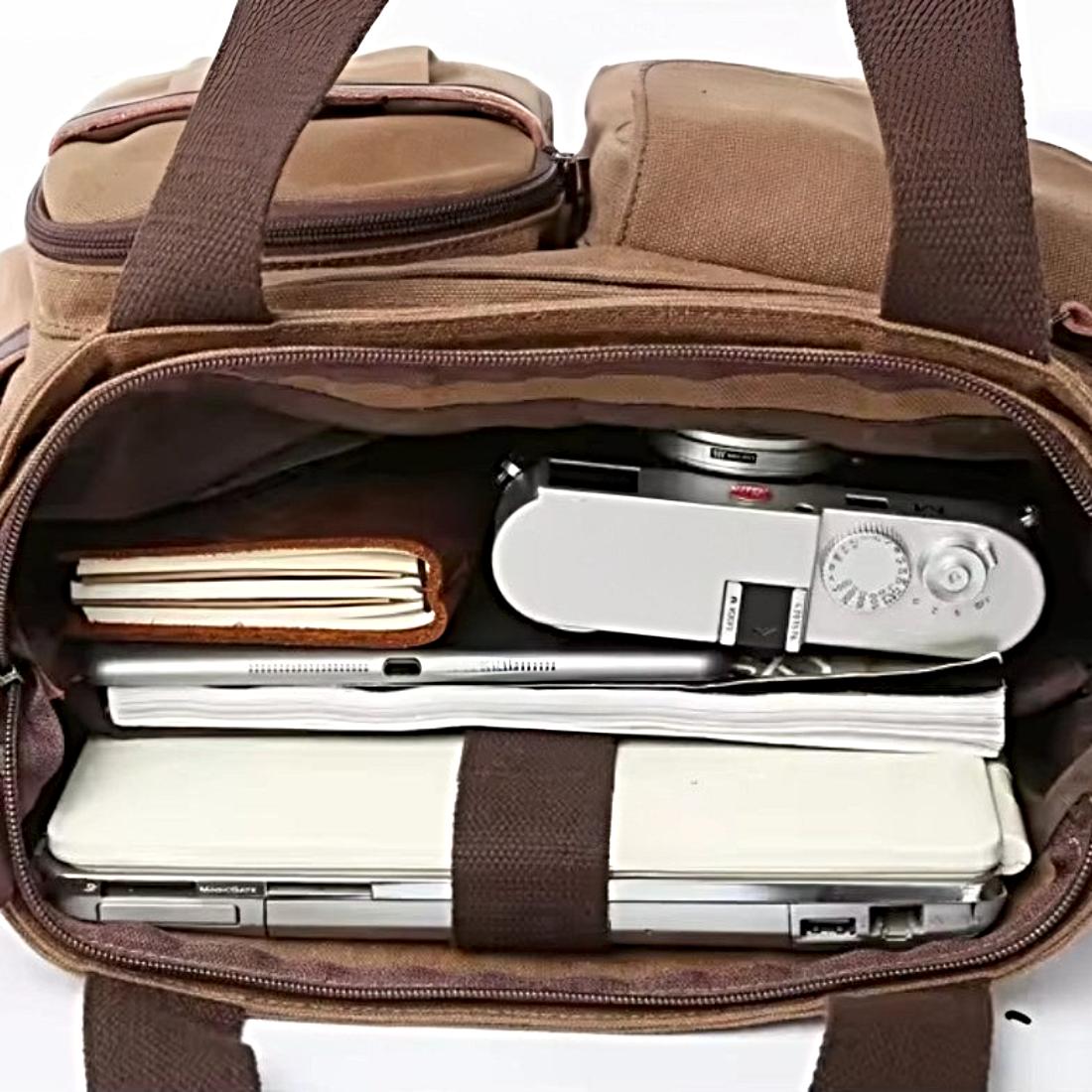 Nomad Utility Carry durable bag in brown canvas shown open with packed interior showcasing durable premium construction organized layout and rugged upscale versatility for everyday carry