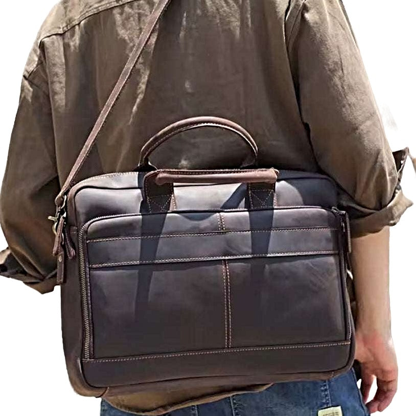 Prestige Leather Briefcase in dark coffee brown full grain genuine leather worn crossbody with dual top handles adjustable shoulder strap and multiple compartments featuring smooth finish refined stitching and upscale rugged texture styled for confident everyday upscale durable carry