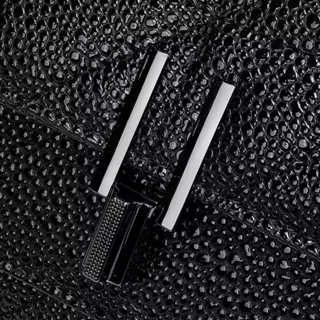 Timeless Quilted Charm luxury vegan leather crossbody in black close up of elegant silver tone turn lock clasp on upscale quilted texture