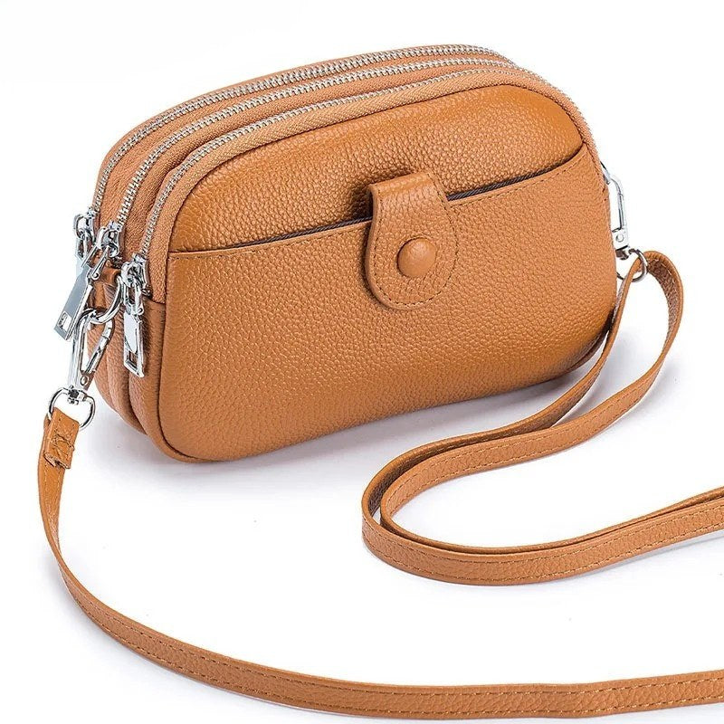 Signature Convertible Carry, women’s crossbody bag in tan genuine leather with detachable strap, 3 zip pockets, silver hardware, front snap pocket