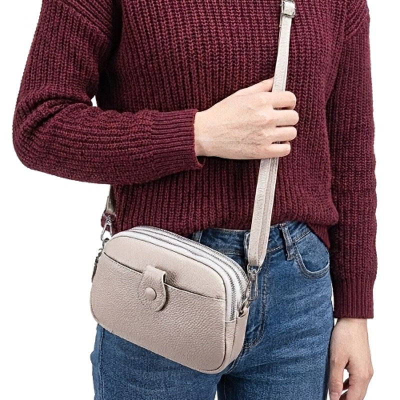 Signature Convertible Carry women’s crossbody bag in taupe leather with detachable adjustable strap 3 zip pockets, front snap pocket with silver hardware
