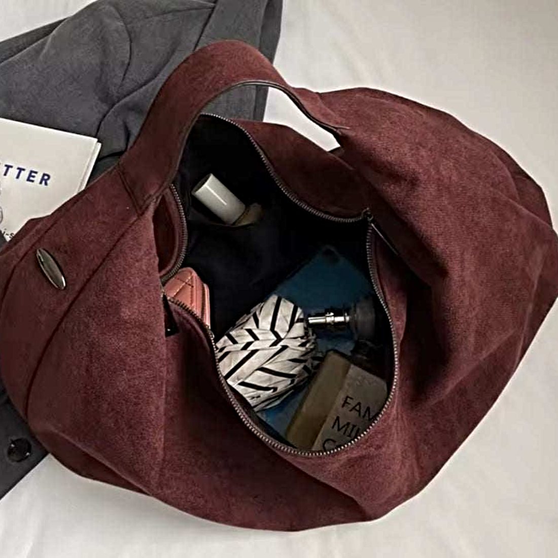Timeless Suede Hobo in luxury burgundy vegan suede with slouchy crescent silhouette single shoulder strap and subtle metallic zippers showcasing upscale velvety texture soft structure and practical everyday elegance carry